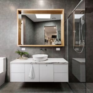 "Single hook holding white towel on modern white floating bathroom vanity"