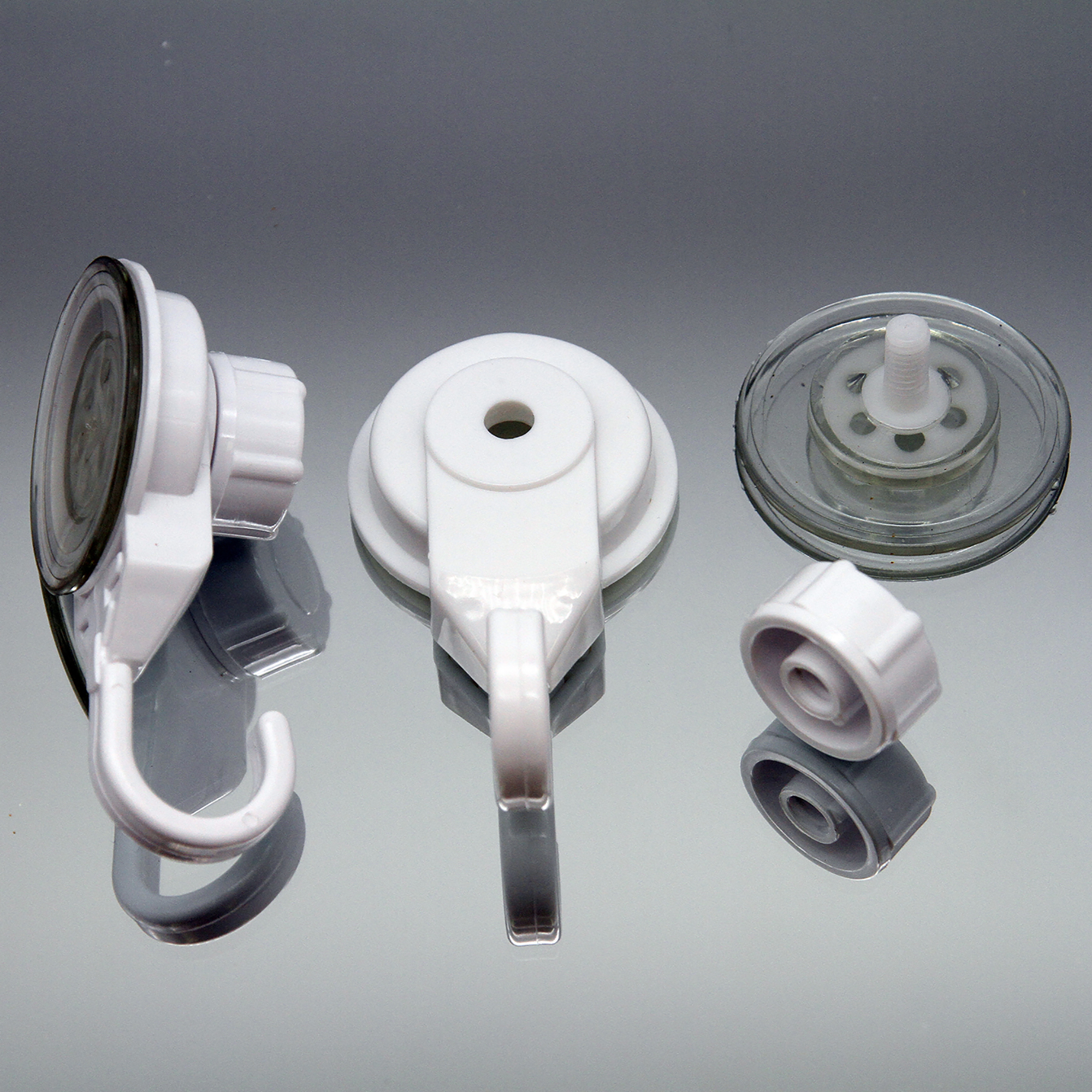 Suction cup hook disassembled showing three components: hook unit, base, and suction cup