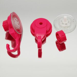 Hot pink suction cup hook disassembled showing three components: hook unit, base, and clear suction cup
