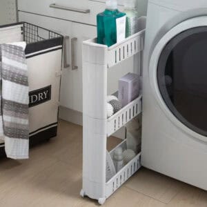 White 3-tier slim rolling cart holding laundry detergent and dryer products, positioned beside a front-load dryer