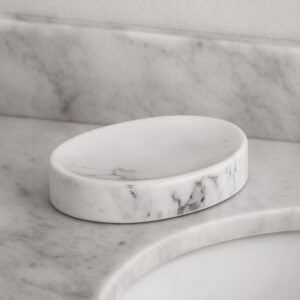 Empty oval marble soap dish on stone countertop