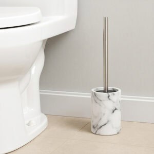 White marble effect toilet brush holder with stainless steel handle beside white toilet