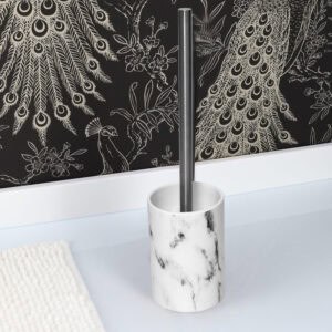White marble effect toilet brush holder with stainless steel handle against black peacock feather wallpaper
