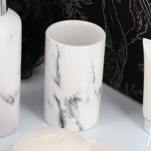 Marble effect bathroom tumbler close-up on countertop