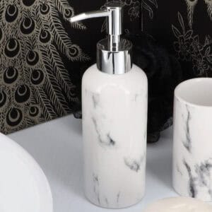 Close-up of marble effect soap dispenser with chrome pump
