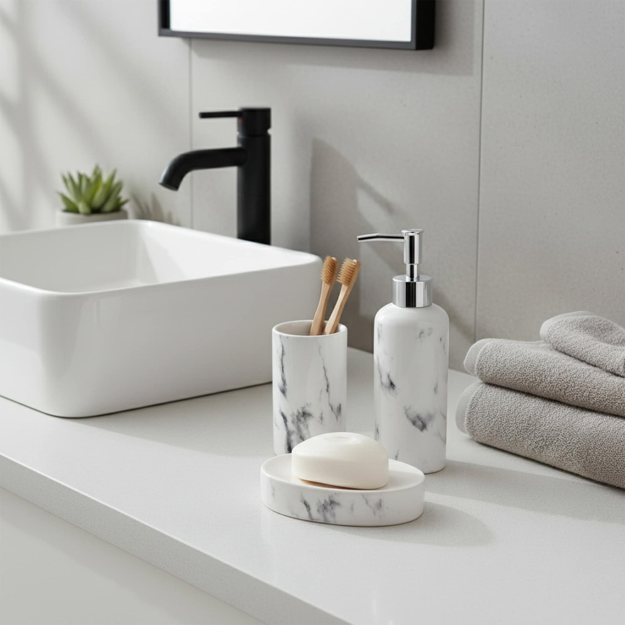 White marble soap dispenser, tumbler, and soap dish on modern bathroom counter