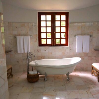 Canva - White Bathtub on White Tile Bathroom Near Brown Framed Clear Glass Window
