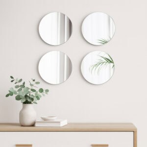 "Set of 4 round frameless wall mirrors arranged in 2x2 grid above a wooden sideboard"