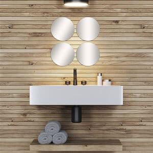 "Four round frameless mirrors grouped above a floating bathroom vanity with wood plank wall"