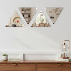 "Four triangle mirrors arranged in alternating up-down pattern on a white wall above a wooden sideboard"