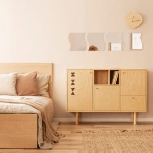 "Four wave-shaped mirrors displayed above a wooden cabinet in a Scandinavian-style bedroom"
