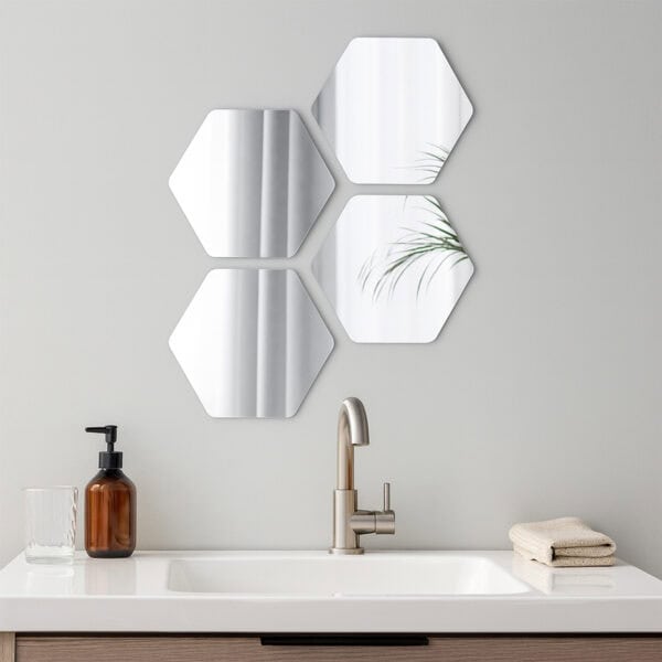 "Four hexagonal mirrors in honeycomb arrangement above a bathroom sink with wood vanity"