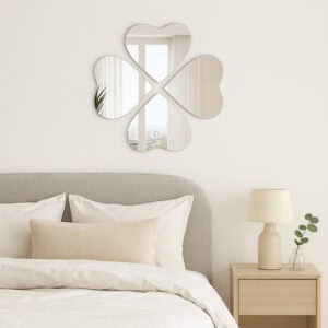"Four heart-shaped mirrors in four-leaf clover arrangement above a bed in a minimalist bedroom"