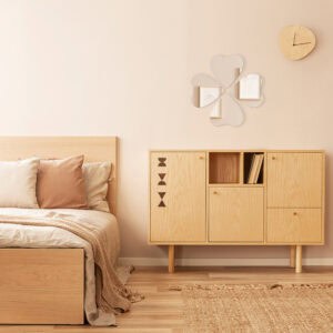 "Four heart-shaped mirrors in four-leaf clover arrangement above a wooden cabinet in a Scandinavian-style bedroom"