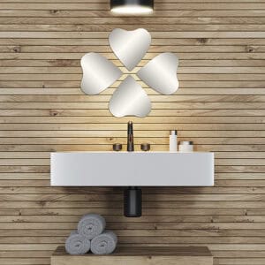"Four heart-shaped frameless mirrors in four-leaf clover arrangement above a floating bathroom vanity with wood plank wall"