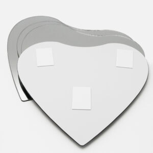 "Back of heart-shaped mirror showing three adhesive foam mounting pads, with additional mirrors stacked behind"