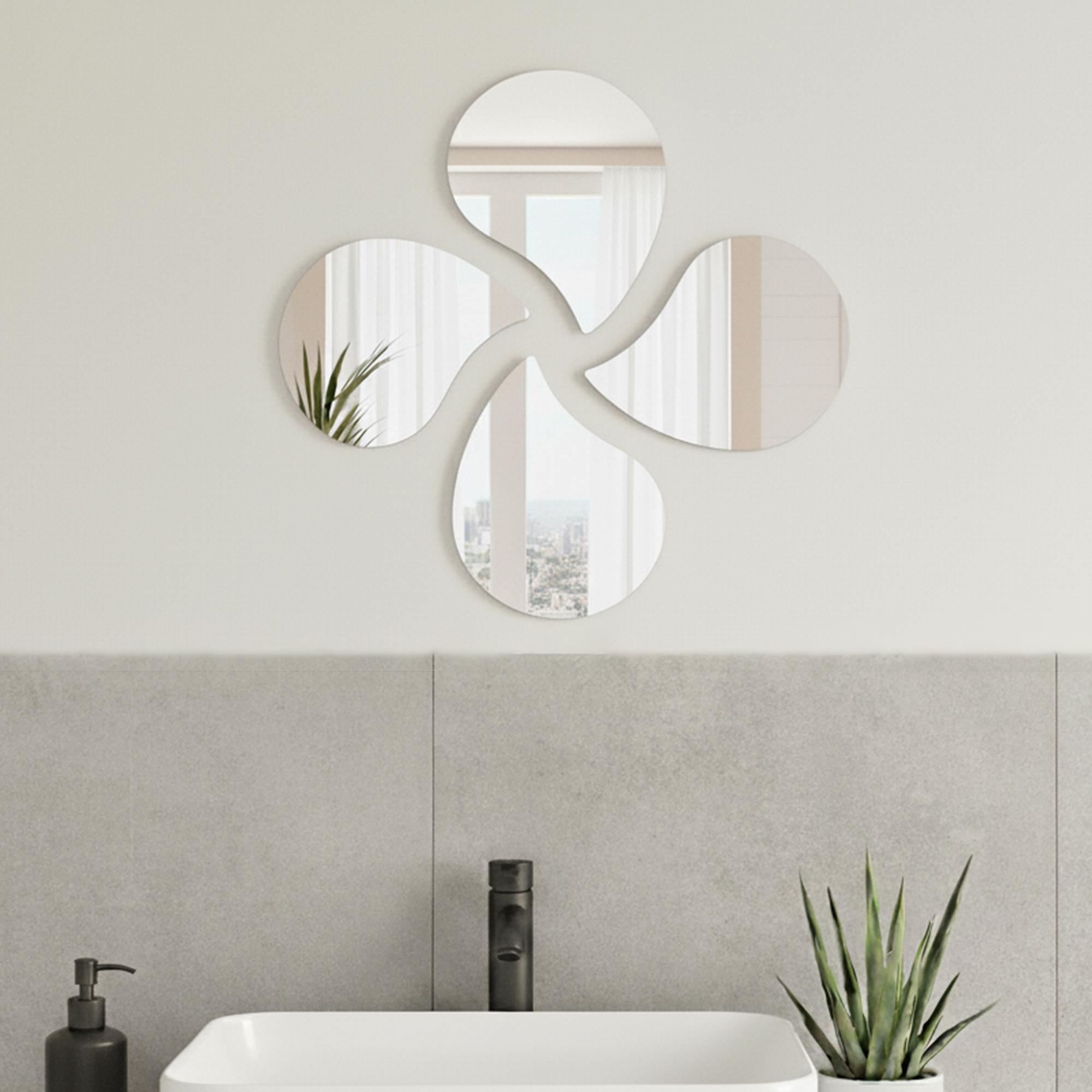 "Four teardrop-shaped mirrors in pinwheel arrangement above a bathroom sink with grey tile wall"