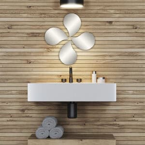 "Four teardrop-shaped frameless mirrors in pinwheel arrangement above a floating bathroom vanity with wood plank wall"