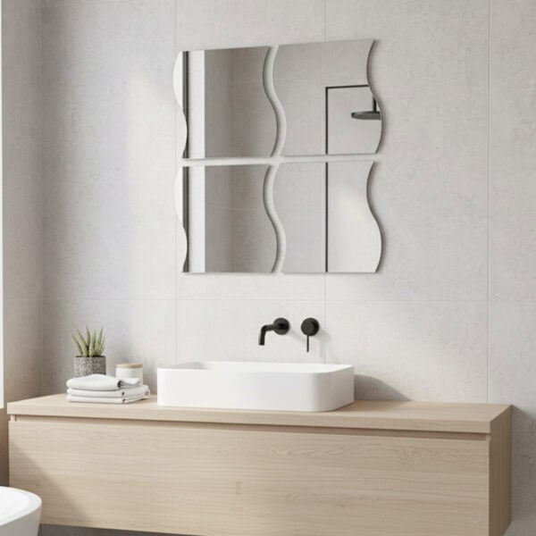 "Four large wave-shaped mirrors in 2x2 grid above a bathroom vanity with vessel sink and grey tile wall"