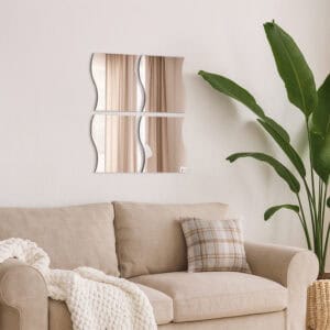 "Four large wave-shaped mirrors in 2x2 grid above a beige sofa in a living room"