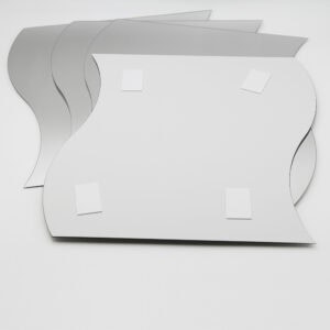 "Back of large wave-shaped mirror showing four adhesive foam mounting pads, with three additional mirrors fanned behind"