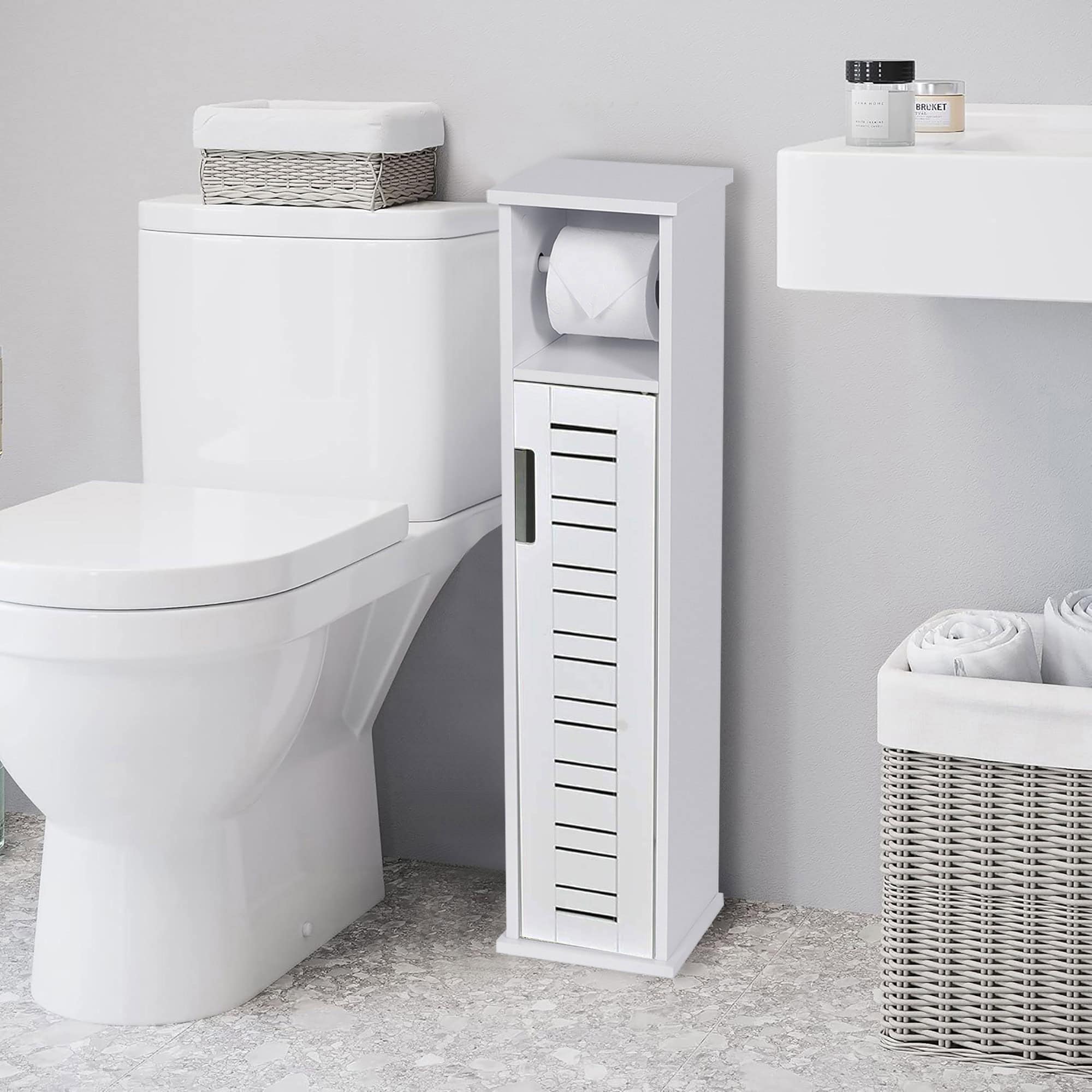 Toilet paper cabinet in modern bathroom setting – Compact white storage cabinet placed beside a toilet in a sleek bathroom with neutral decor, holding bathroom accessories.