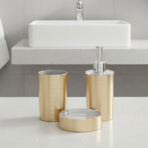 Brushed gold bathroom accessory set arranged on white background