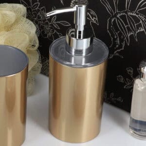 Brushed gold soap dispenser close up with pump detail