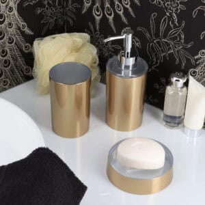 Brushed gold soap dispenser styled with bathroom accessories