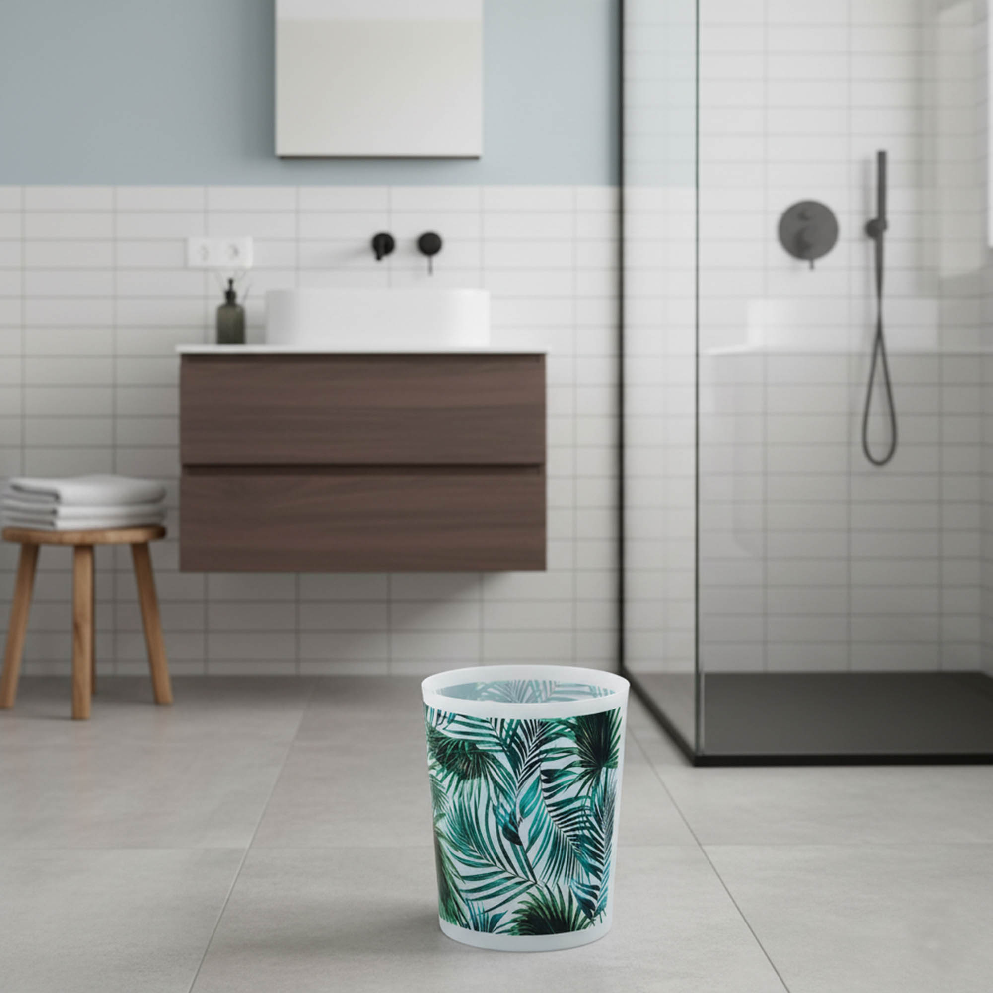 Decorative tropical trash can on bathroom floor near vanity