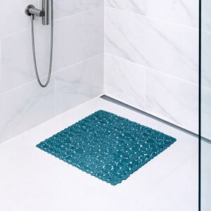 Peacock blue bubble-pattern shower mat on tile shower floor