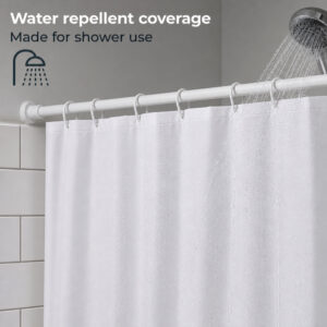Close-up of a white polyester shower curtain hung with white rings on a rod under a running shower head