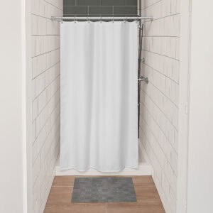 White stall shower curtain installed in small tiled shower space