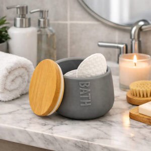 Gray cotton box holding cotton pads on marble bathroom counter