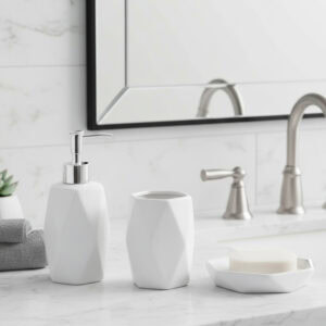 White soap dispenser with matching tumbler and soap dish on marble counter