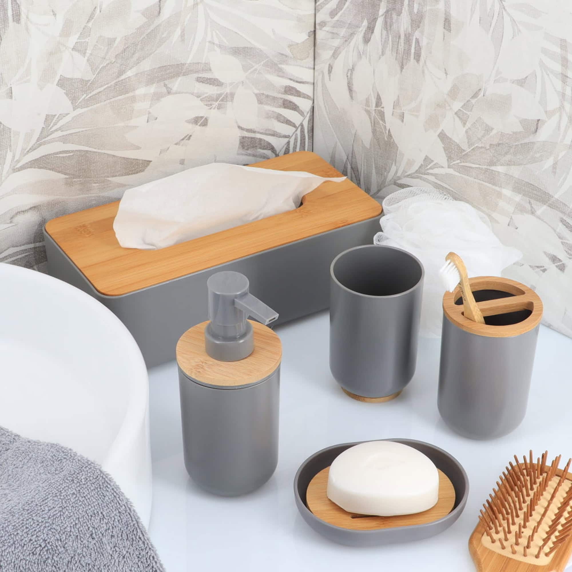 Coordinated gray and bamboo bathroom accessory set on countertop