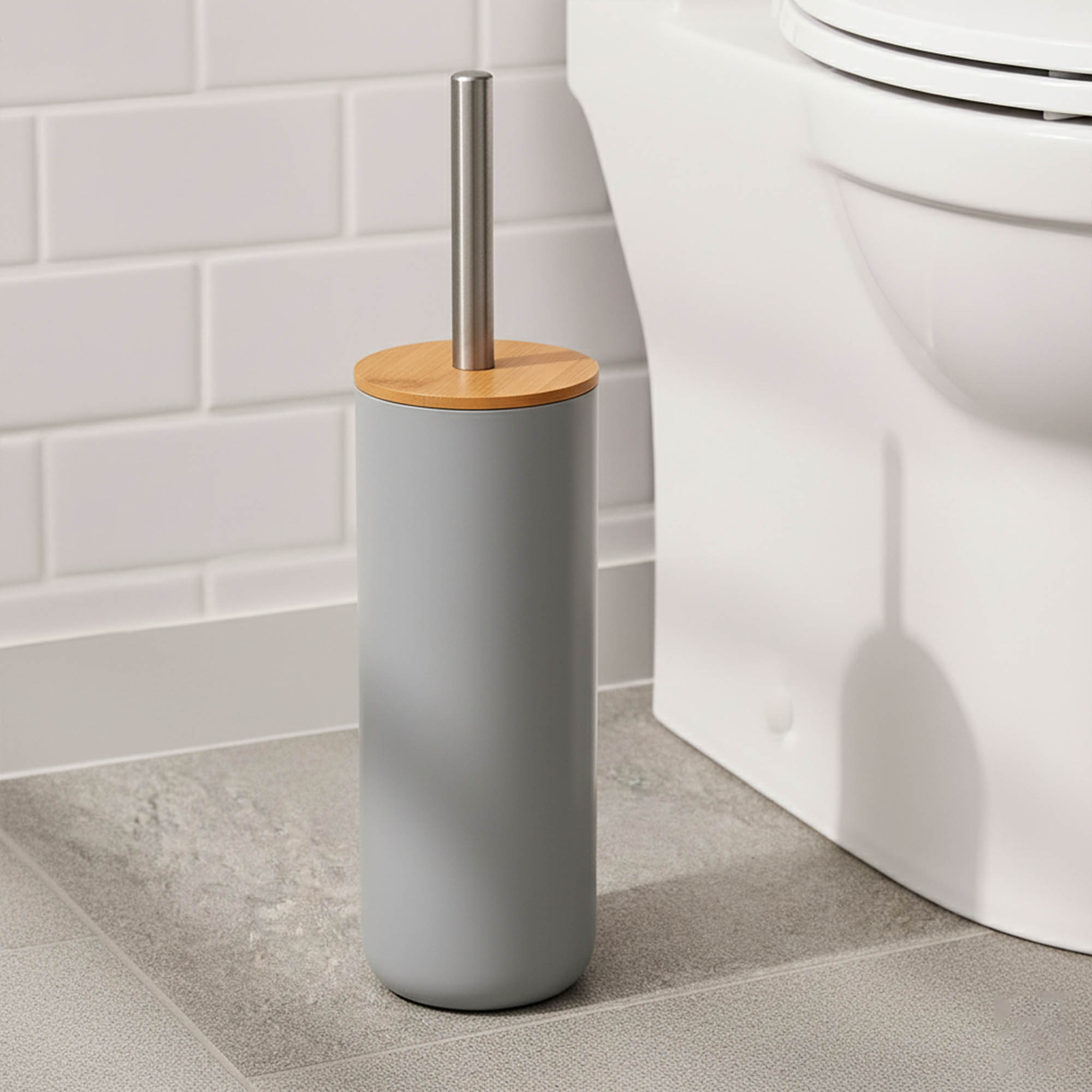 Gray toilet brush with bamboo lid and stainless steel handle beside white toilet in modern bathroom