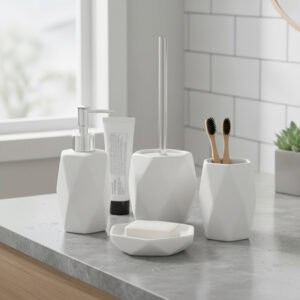 White diamond-shaped bathroom accessory set with toilet brush, soap dispenser, toothbrush holder, and soap dish on gray countertop