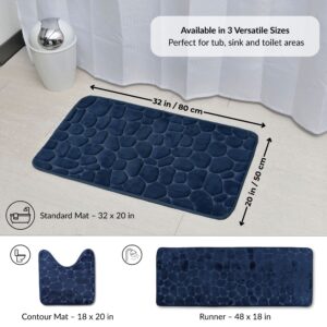 Navy blue pebble bathroom mat displayed in 32x20 in standard size with illustrations of contour and runner shapes and labeled dimensions