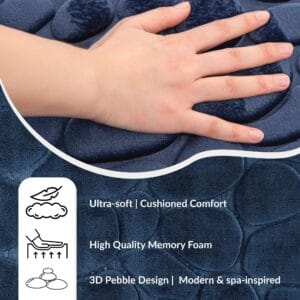 Hand pressing into soft navy blue mat surface showing cushioned texture, memory foam benefits, and 3D pebble design