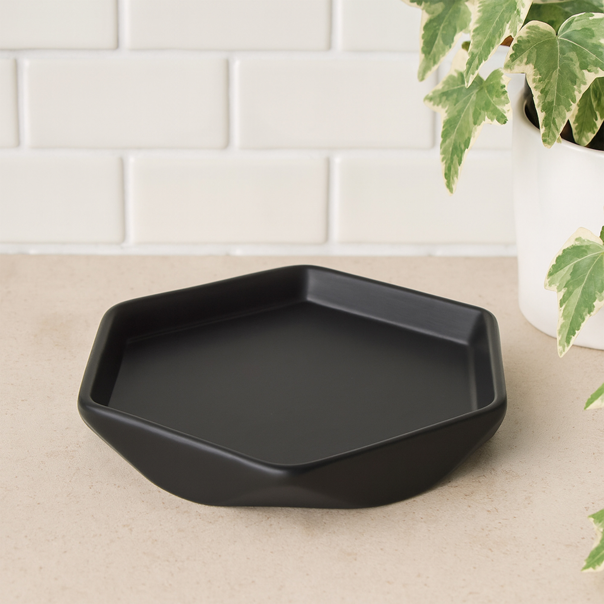Empty matte black geometric soap dish on counter
