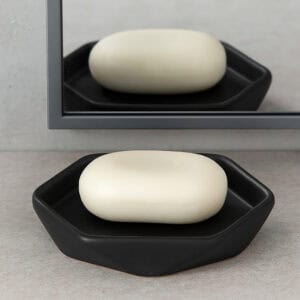Black soap dish with oval soap reflected in mirror