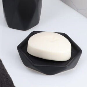 Black soap dish with bar soap close up
