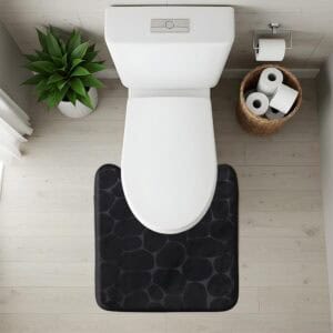 Top-down view of black pebble-texture contour mat fitted around toilet base