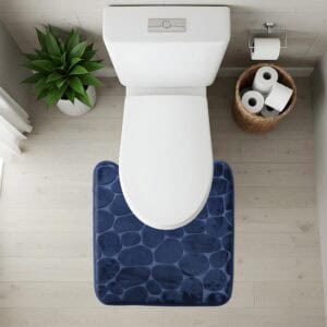 Top-down view of navy blue pebble-texture contour mat fitted around toilet base