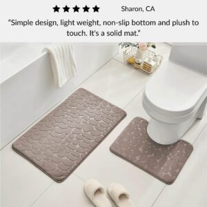 Taupe contour and standard memory foam mats with pebble design positioned around toilet with slippers and customer review overlay