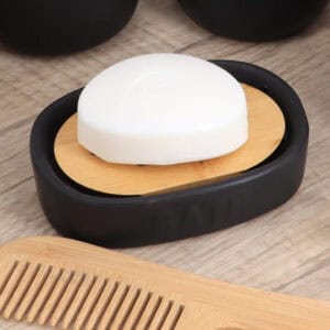 Side view of black soap dish with bamboo anti melt tray