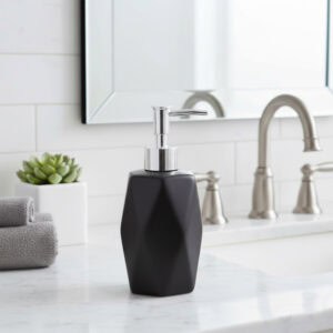 Black geometric soap dispenser with chrome pump on marble vanity