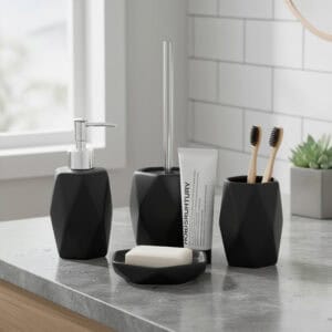 Matte black bathroom accessory set styled on countertop with toothbrushes and soap