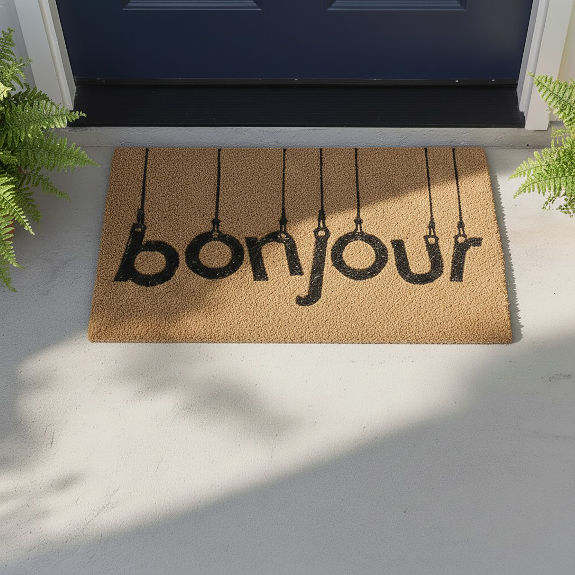Natural coir doormat with “bonjour” text placed in front of a blue entry door